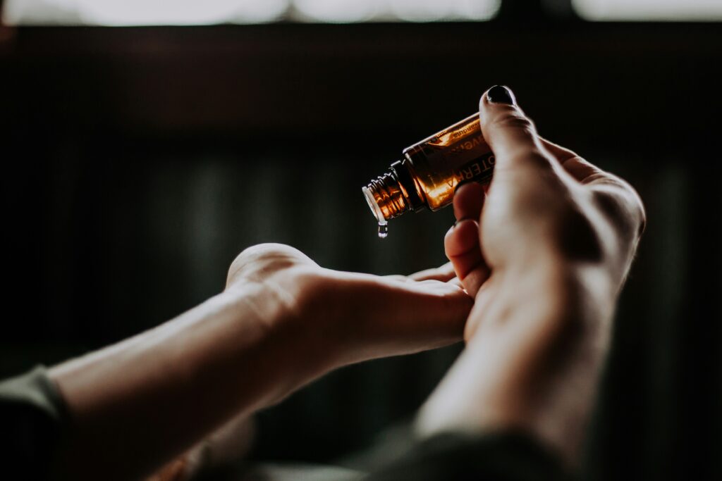 Person is taking essential oil drop in hands