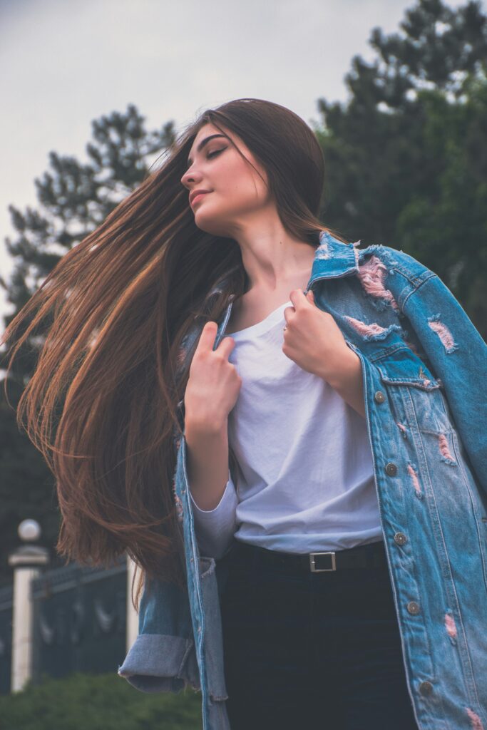 a girl is showing her smooth hair 