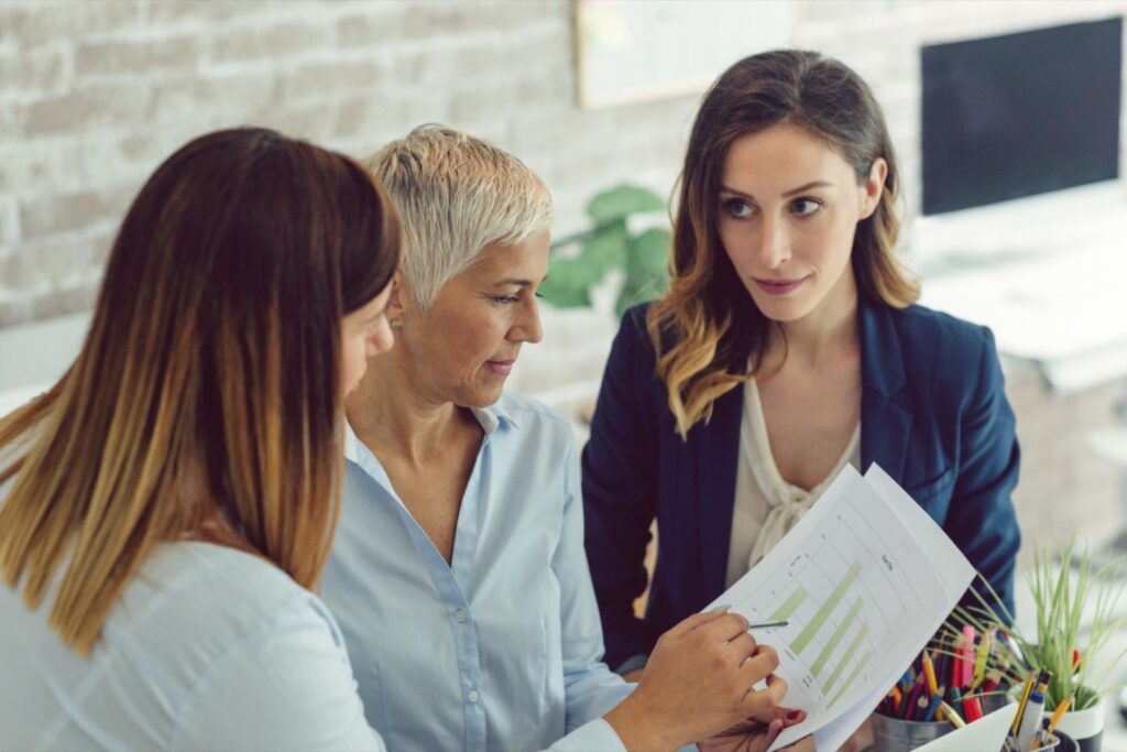 THREE WOMEN ARE DISCUSSING SOMETHING 