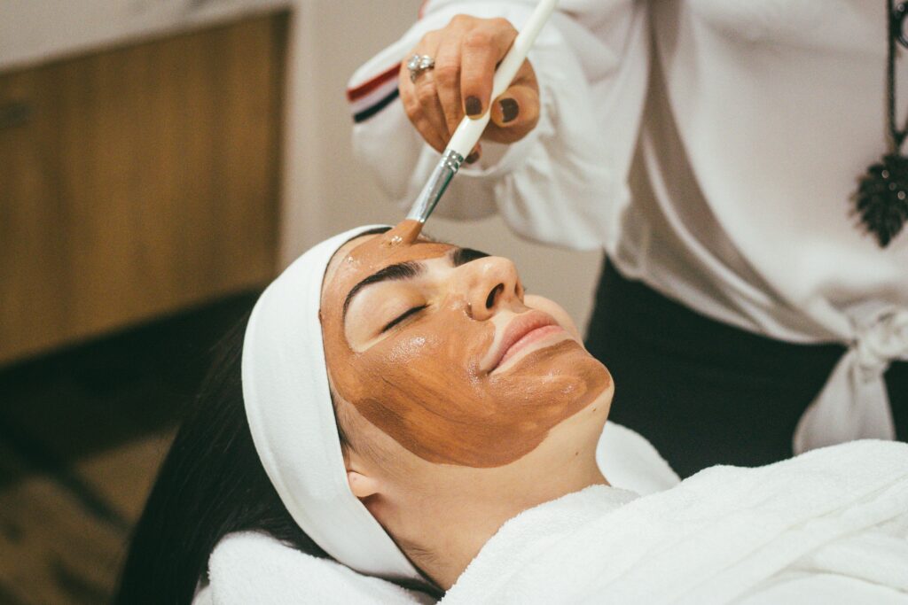 A women is doing facial on her face 